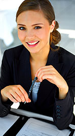 Photo of smiling young business woman with pen in her hand